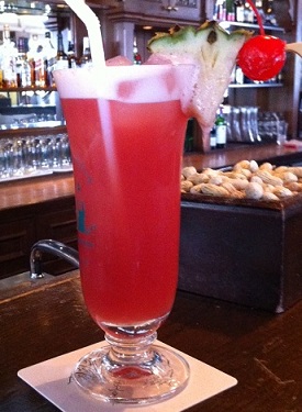 Drinking a Singapore Sling at the Raffles Hotel