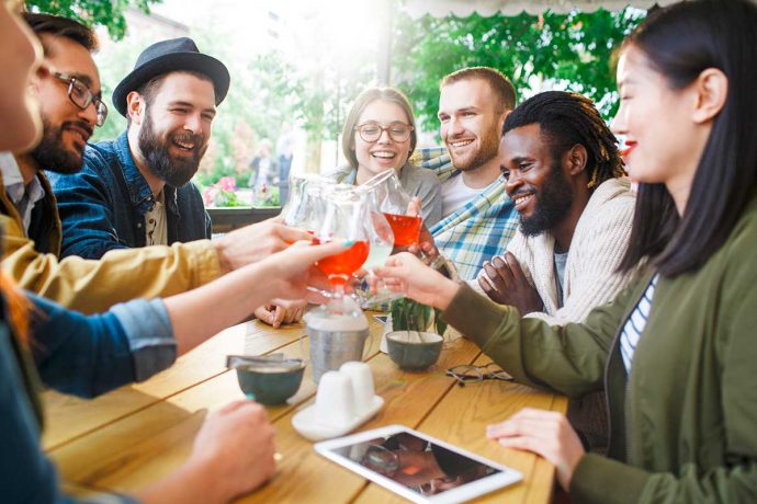 Diverse friends clinking glasses | Bevvy