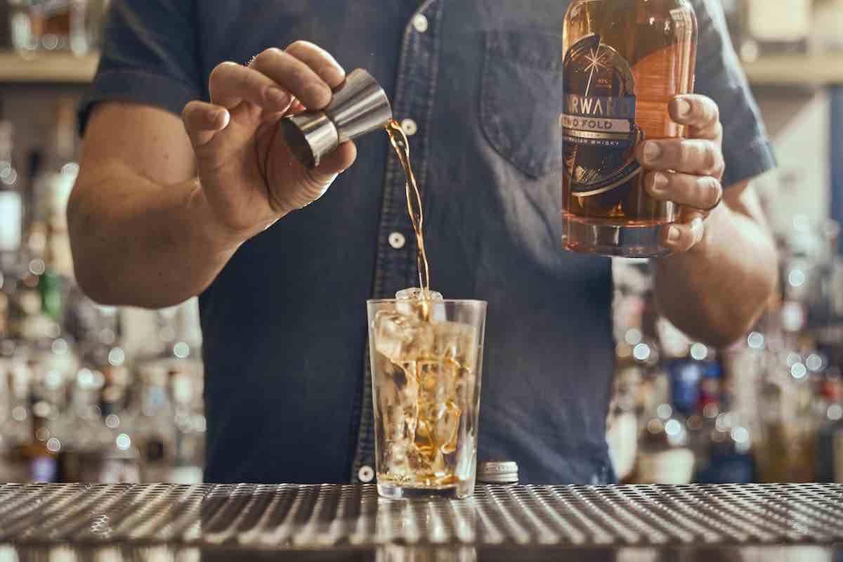 bartender making whiskey cocktail