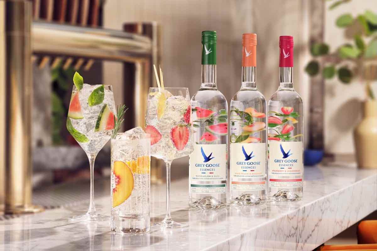 three grey goose essences cocktails with vodka bottles