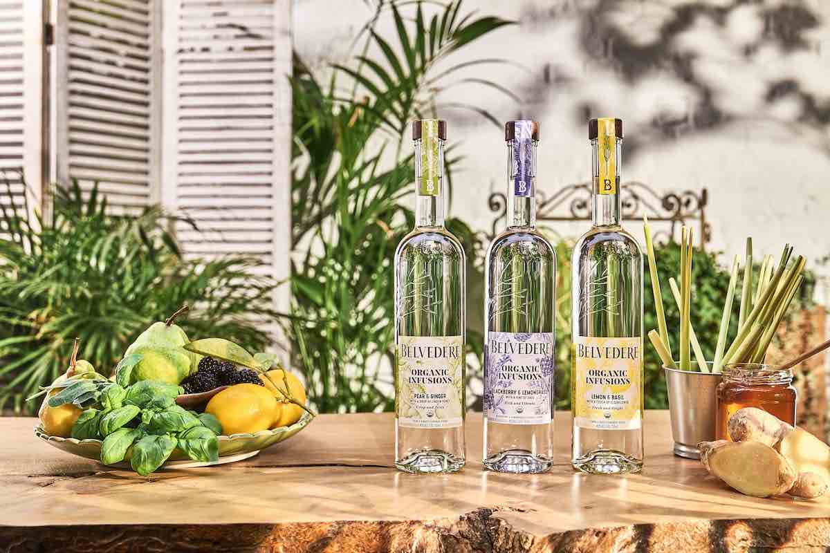 3 belvedere organic infusions vodka bottles on a wooden table