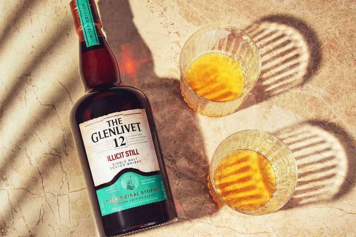 The Glenlivet Illicit Still whisky bottle with two glasses