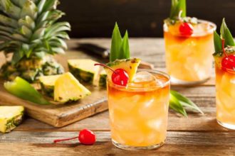 mai tai cocktails with cherry and pineapple garnish