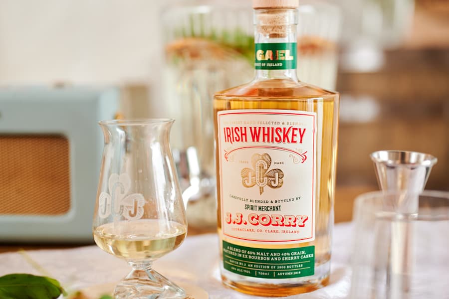 J.J. Cory Irish Whiskey The Gael Irish whiskey bottle with glasses on a table