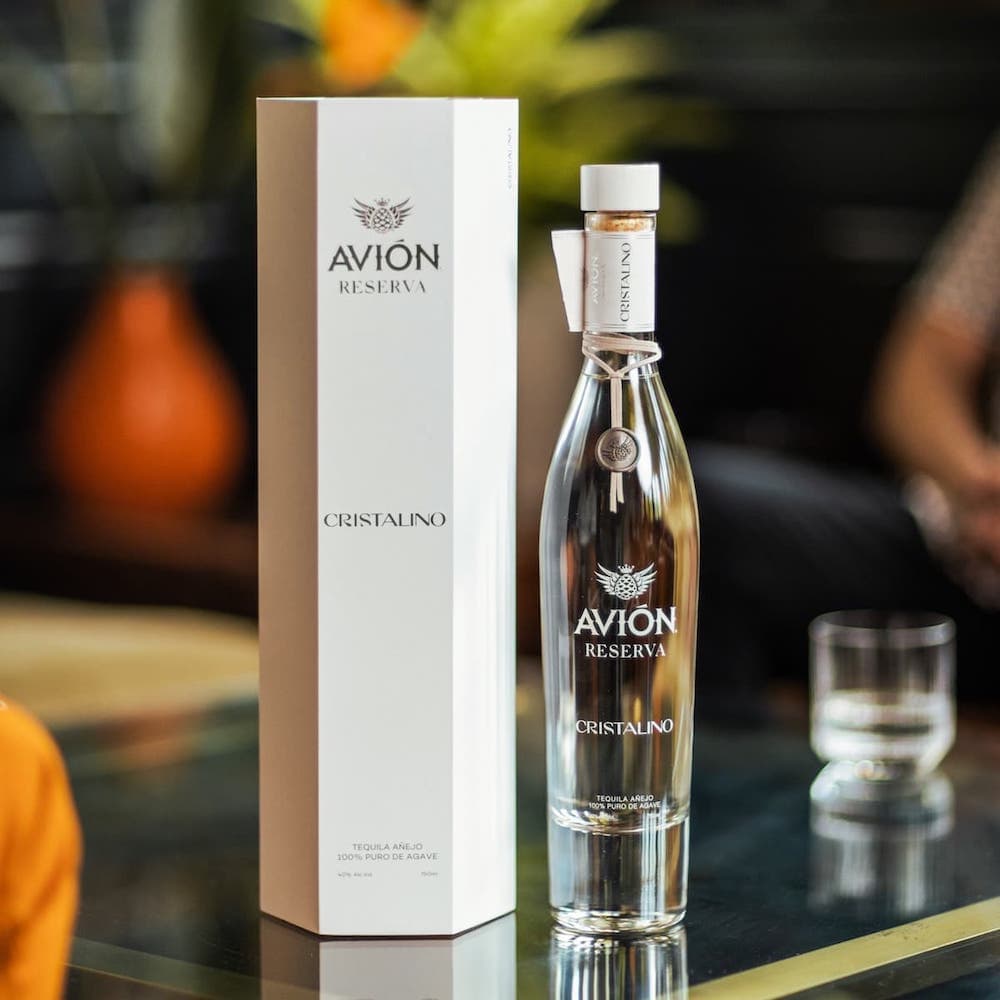 Avion Tequila Cristalino bottle and box on a glass table