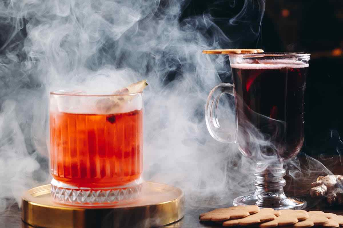 two cocktails surrounded in smoke