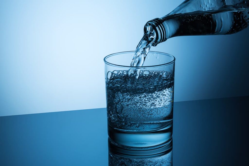 pouring mineral water in a glass