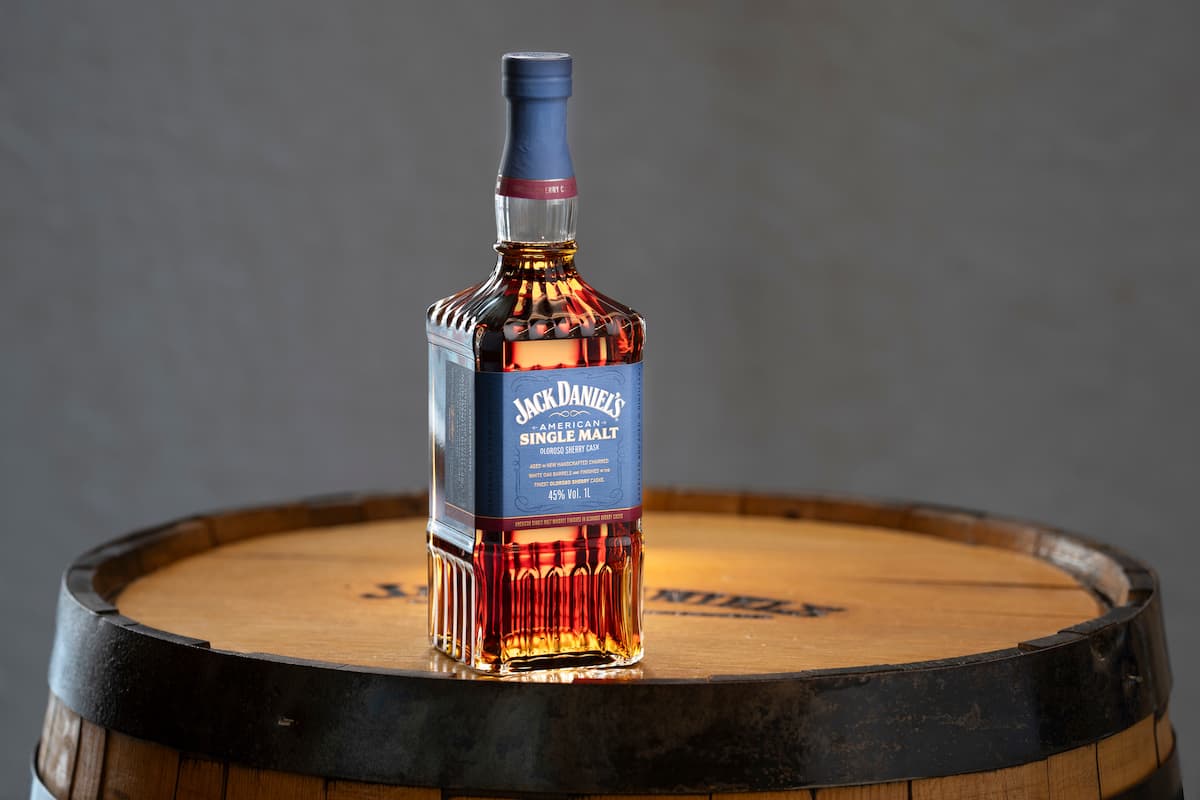 a bottle of Jack Daniel's American Single Malt whiskey on a barrel