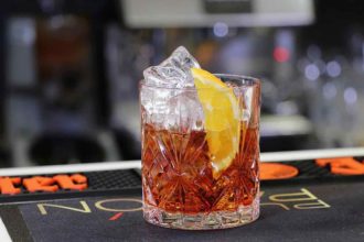 negroni cocktail with ice and an orange slice