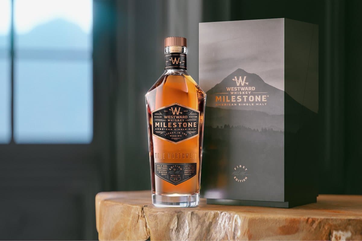 a bottle of Westward Whiskey Milestone and its box on a wood table